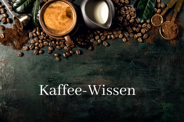 Bild aus Vogelperspektive, Kaffeebohnen plus Kaffeetasse und Milchkännchen im oberen Teil; Schriftzug Kaffee-Wissen auf Tischplatte in Holzoptik